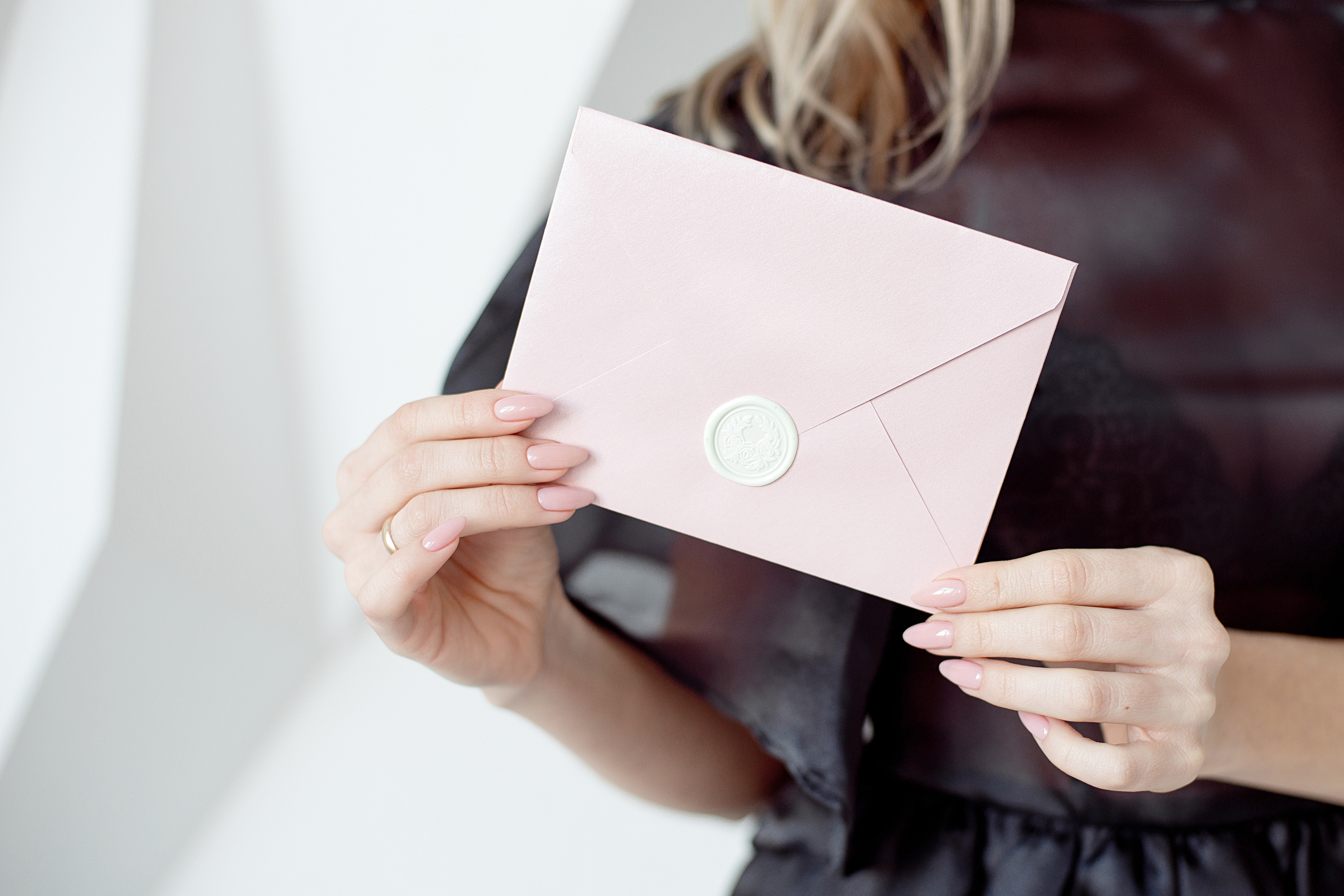 woman holding an envelope