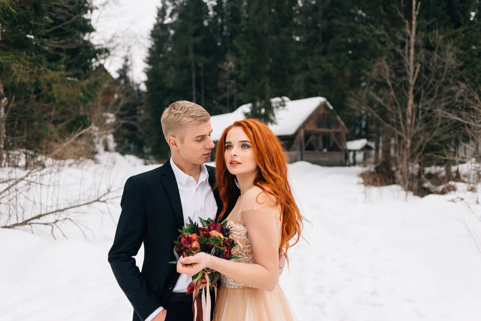 A wedding wedding with bride and groom stood in snow
