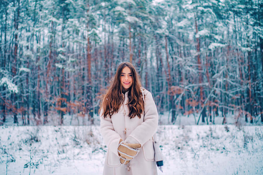 A woman stood in a snowy woods