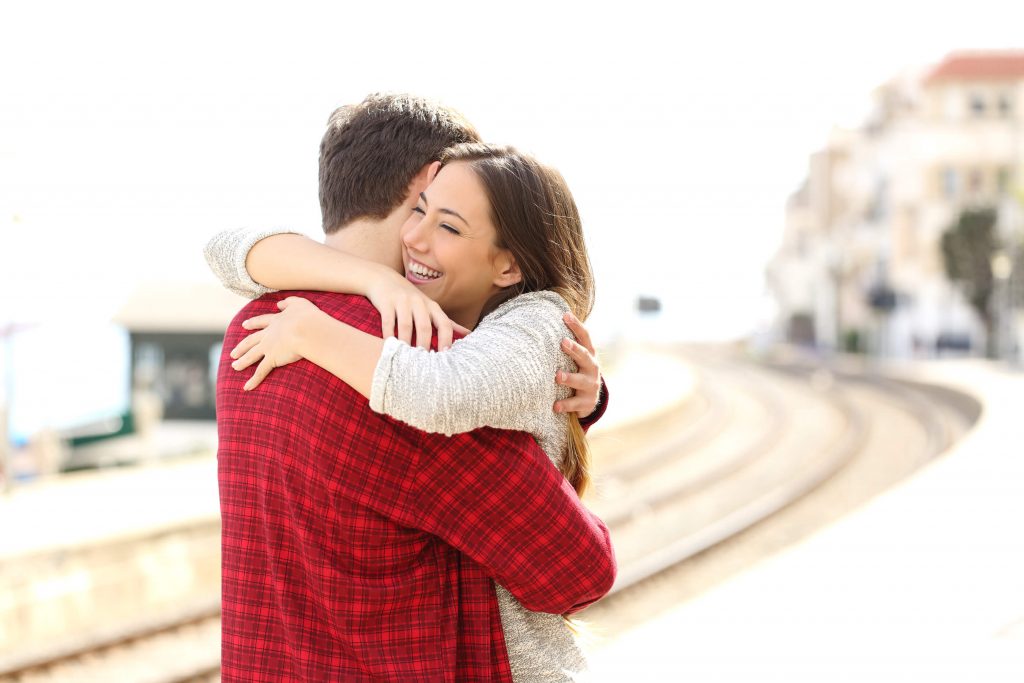 A couple hugging after engagement proposal