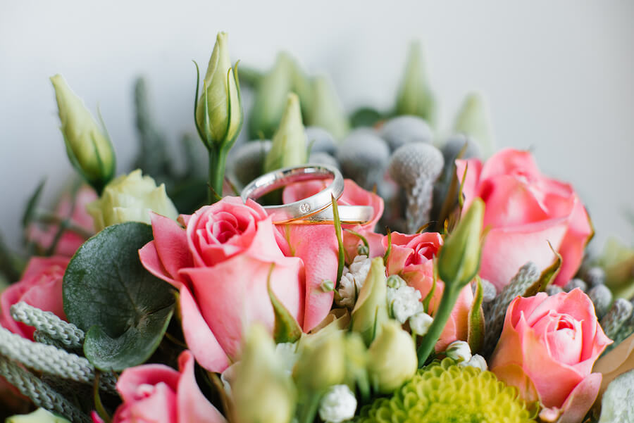 wedding rings on a flower bouquet