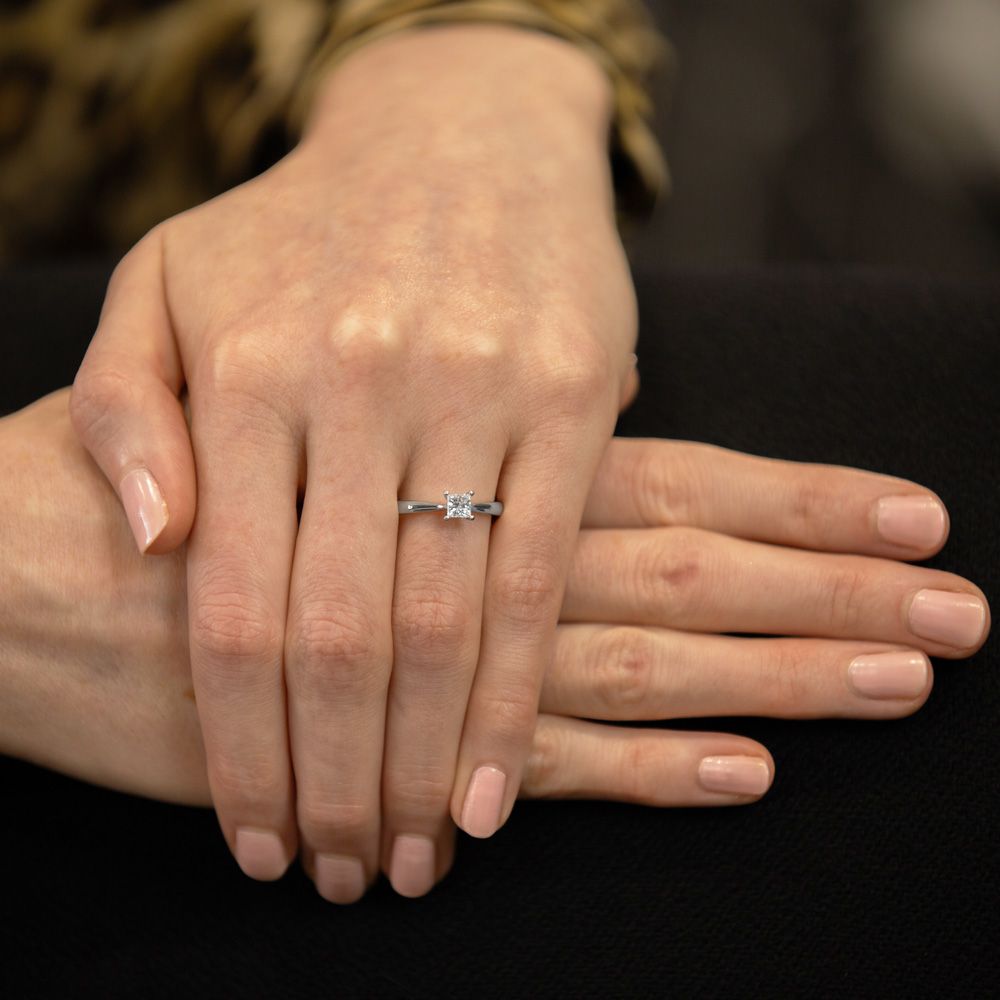 A Robert Gatward Jewellers platinum princess cut diamond engagement ring being worn on the ring finger