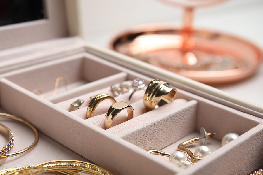 Jewelry box with stylish golden bijouterie, closeup view